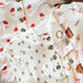 Baby clothes with Christmas-themed patterns on a white background
