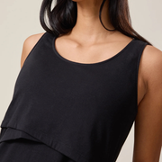 Black sleeveless top worn by a person on a neutral background