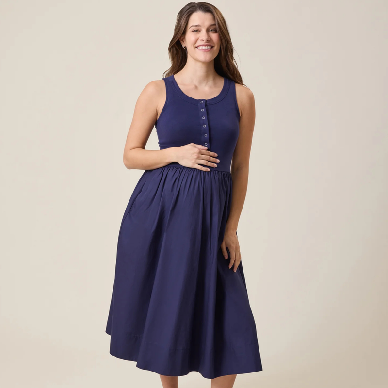 Woman wearing a navy blue dress on a beige background