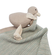 Knitted duck toy on a textured blanket with a white background