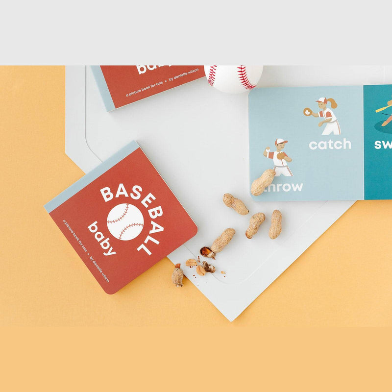 Baseball Baby board book with peanuts, open to the catch and throw pages