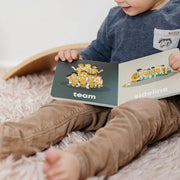 Toddler reading the Basketball Baby board book