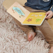 Child reading the Beach Baby board book