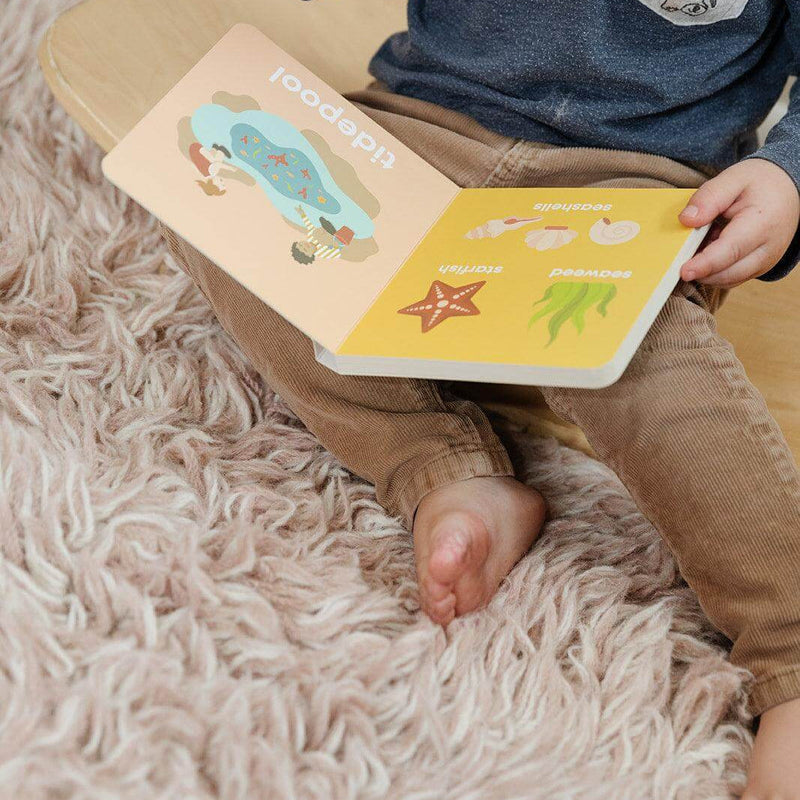 Child reading the Beach Baby board book