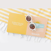 Beach Baby board book open to the beach page with sunglasses