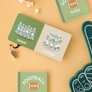 Football Baby board book open to the team page with a foam finger