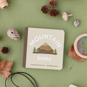 Mountain Baby board book with pinecones and toy camping gear
