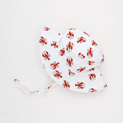 White sun hat with red lobster pattern on a white background