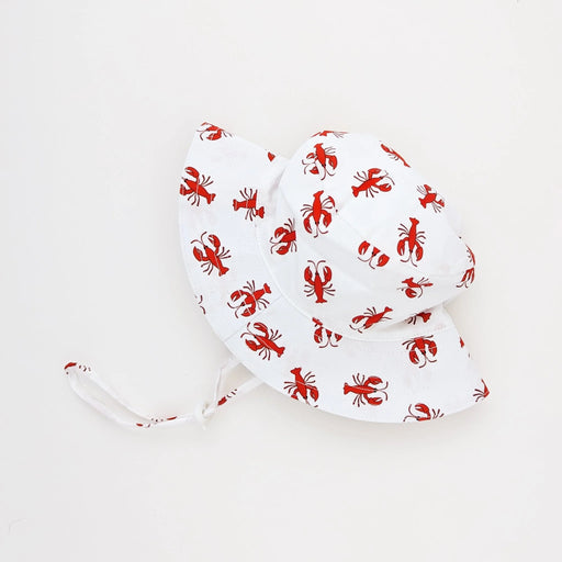 White sun hat with red lobster pattern on a white background