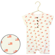 Baby romper with flag pattern on a hanger against a white background