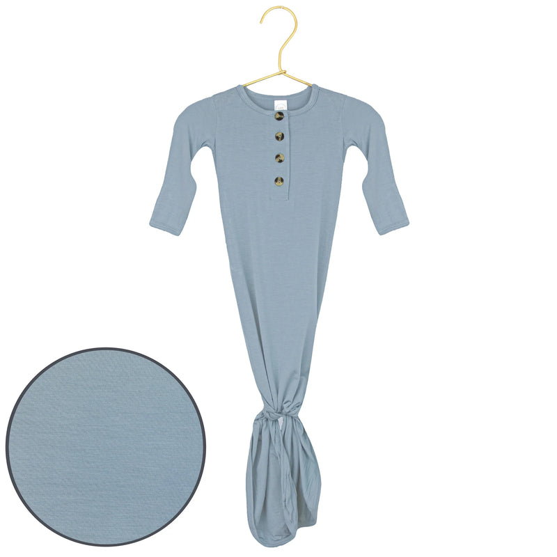 Blue baby gown on a hanger with a close-up of the fabric texture.