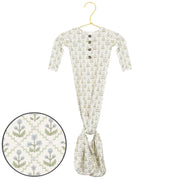 Floral-patterned baby onesie on a hanger with a close-up of the pattern.