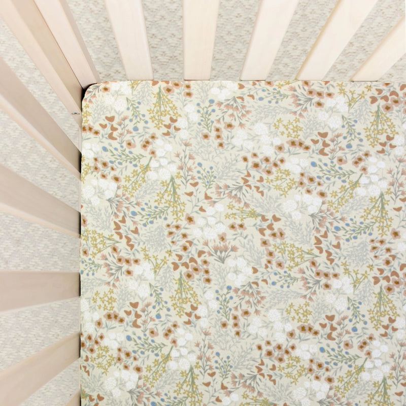 Floral patterned crib sheet inside a crib