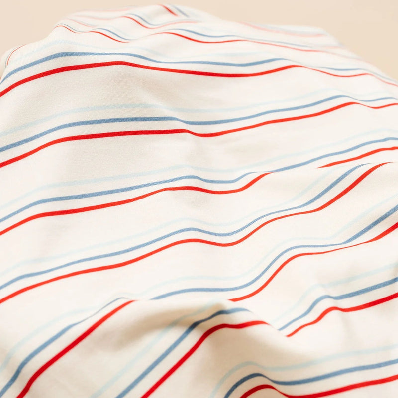 Close-up of fabric with red and blue stripes on a beige background