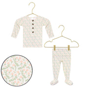 Baby outfit with floral pattern on a hanger against a white background