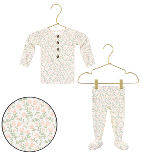 Baby outfit with floral pattern on a hanger against a white background