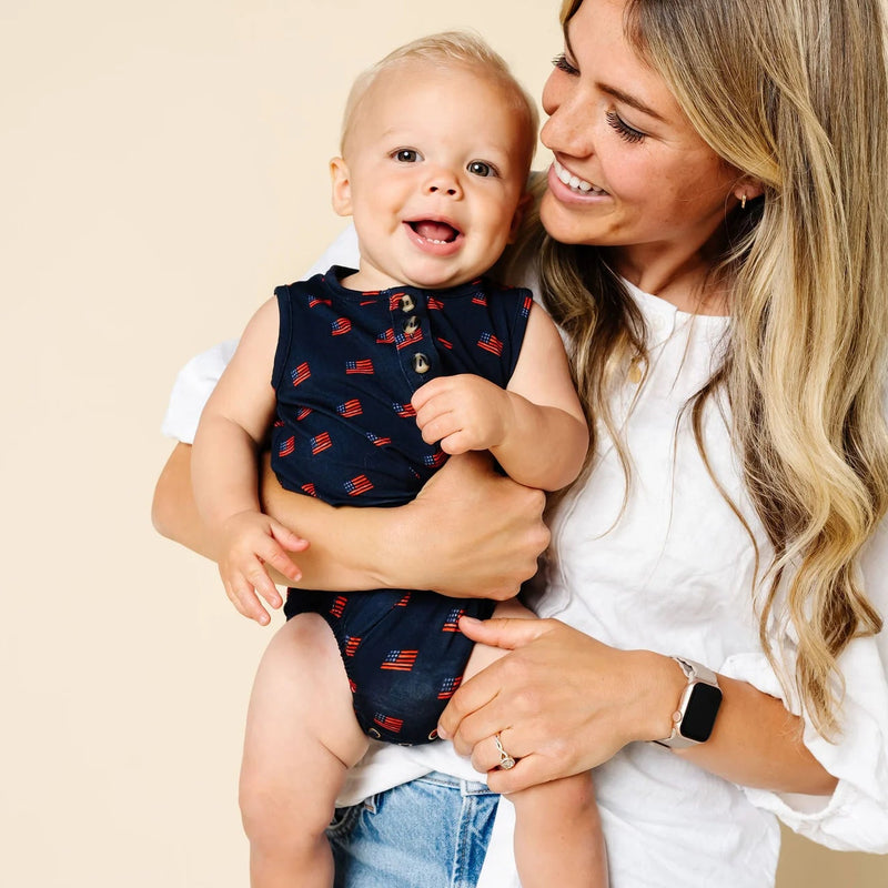 Woman holding a baby with a plain background
