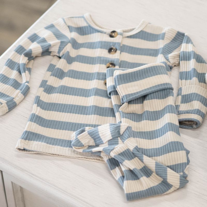 Blue and white striped baby outfit on a light surface