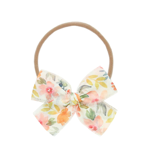 Floral bow hair accessory on a white background