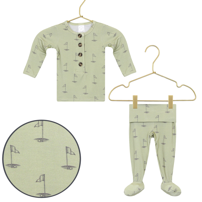 Lou Lou & Co Cal newborn top and bottom set in soft sage green with golf flag print, displayed on hangers