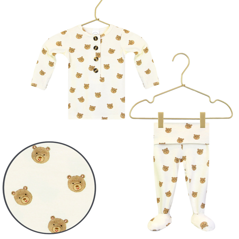 Lou Lou & Co Teddy newborn top and bottom set in cream with tan bear print displayed on hangers