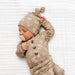 Newborn baby wearing Lou Lou & Co Wyatt print top and bottom set with matching knotted hat in neutral tan western pattern