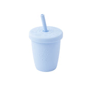 Light blue tumbler with straw on a white background