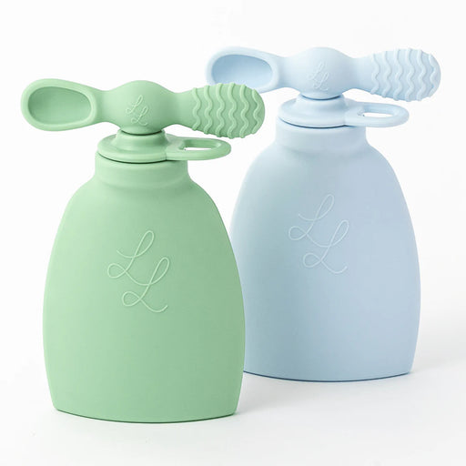 Two silicone baby bottles, one green and one blue, on a white background.