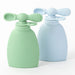 Two silicone baby bottles, one green and one blue, on a white background.