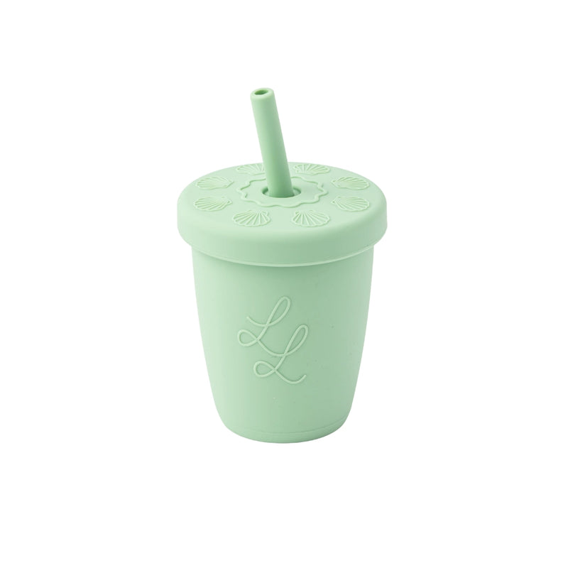 Mint green tumbler with straw lid on a white background