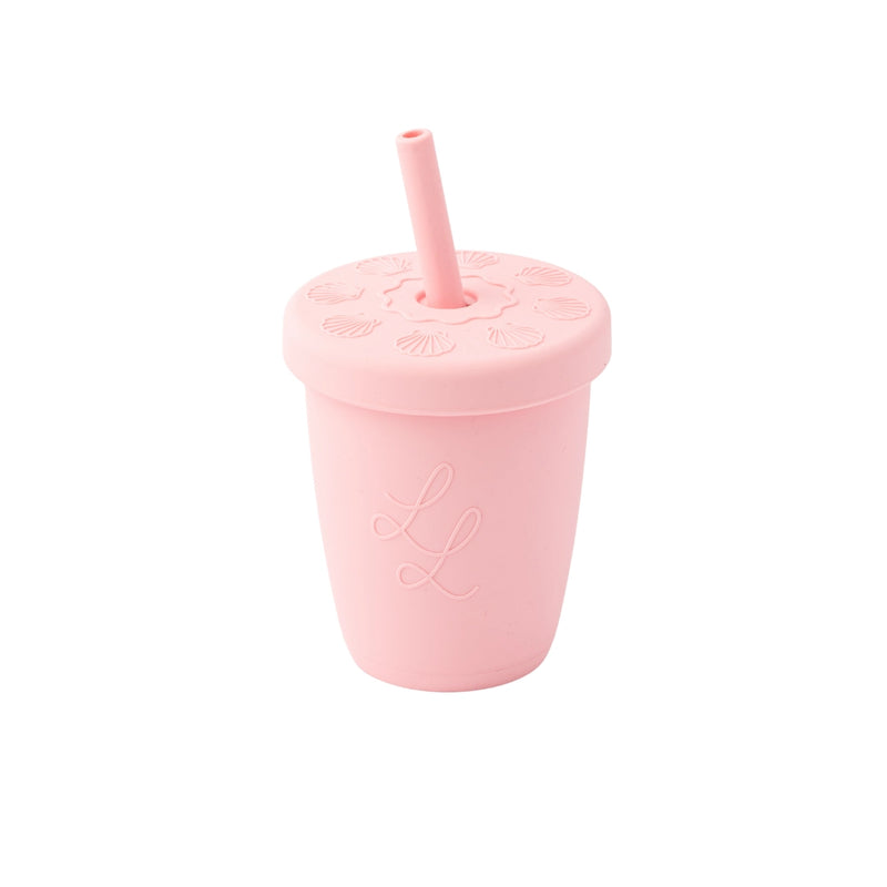 Pink silicone straw cup with a straw on a white background