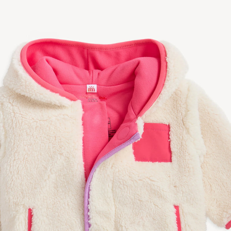Close-up of gentle cream sherpa jacket showing organic cotton lining and magnetic placket