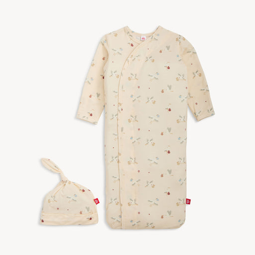 Baby sleep bag with floral pattern and matching hat on a white background