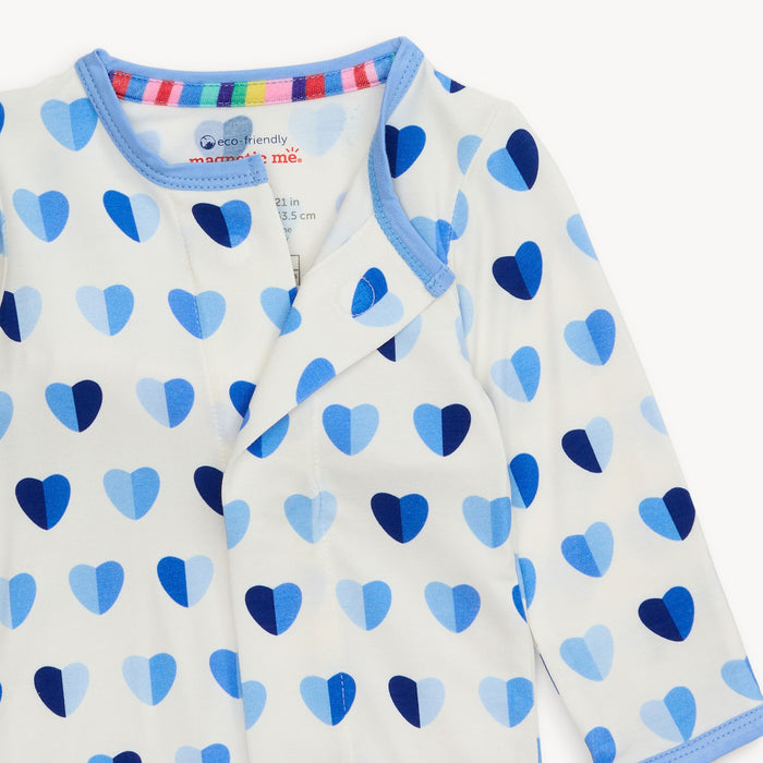 Close-up of Magnetic Me Footie neckline showing magnetic closure and colorful inner collar trim