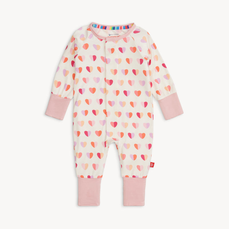 Full view of Magnetic Me Convertible Coverall in Pink XOXO print with pink cuffs and allover heart pattern
