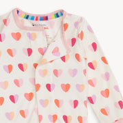 Close-up of Magnetic Me Footie neckline showing magnetic closure and colorful inner collar trim