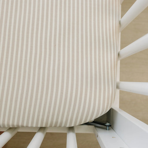 taupe stripe ribbed bamboo crib sheet on mattress corner closeup