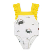 One-piece baby toddler girl swimsuit with yellow straps and crab pattern on a white background