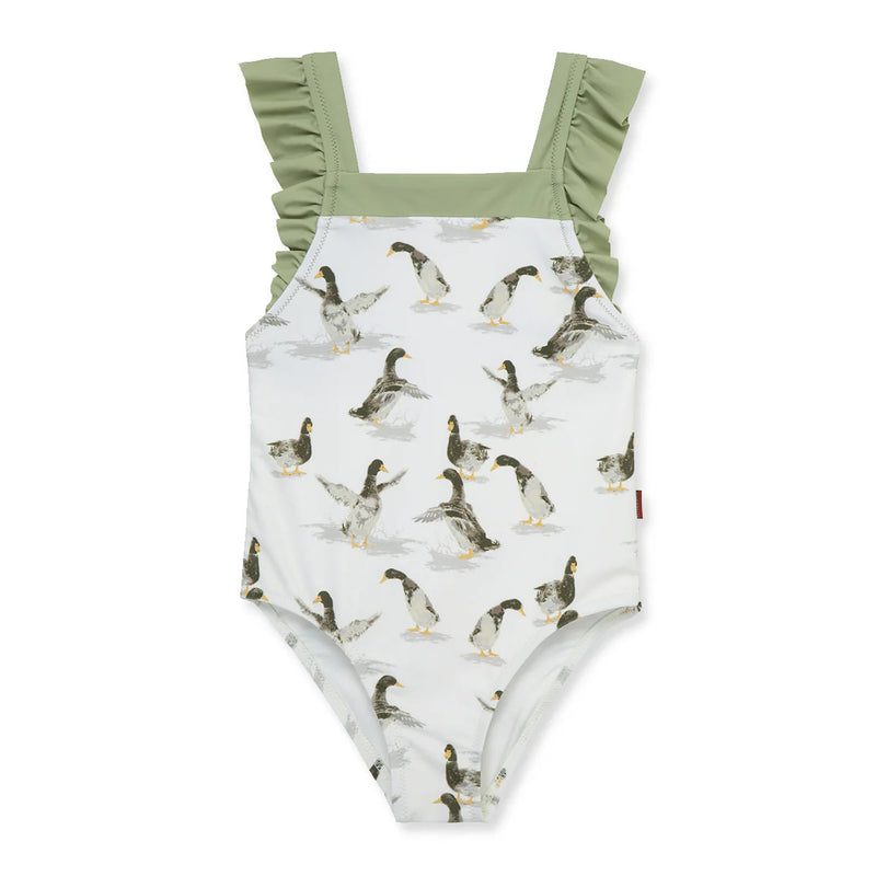 Children's swimsuit with mallard duck pattern and green ruffle straps on a white background