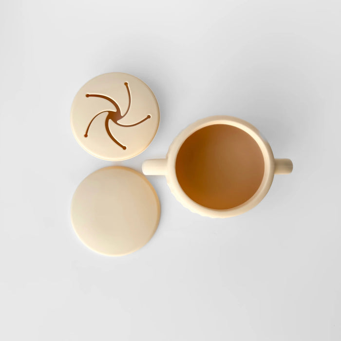 Top view of Miller Snack Cup with petal-style lids in soft cream and tan tones on a white surface.