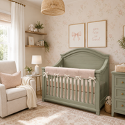 Nursery room with a green crib, beige armchair, and decorative elements.