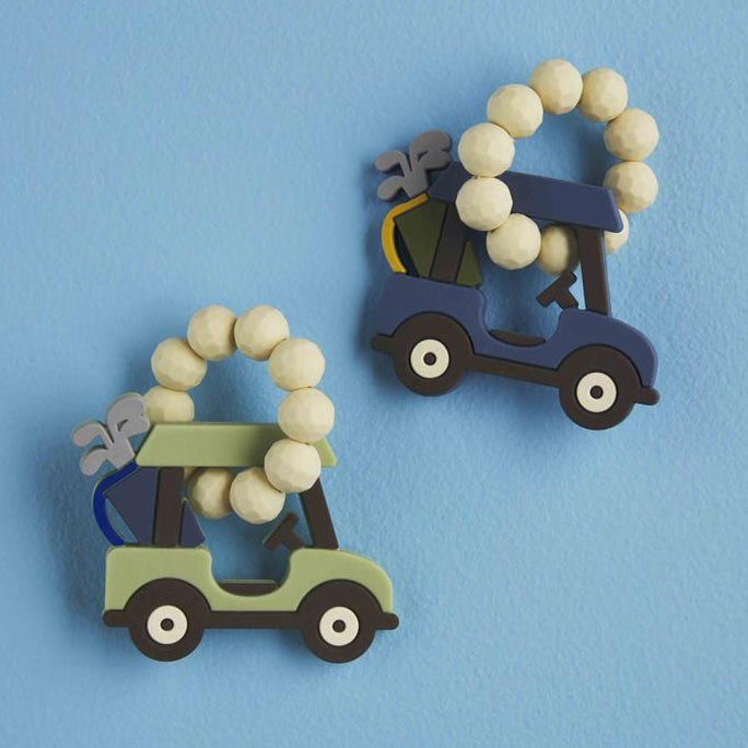 Two decorative items shaped like golf carts with bead accents on a blue background