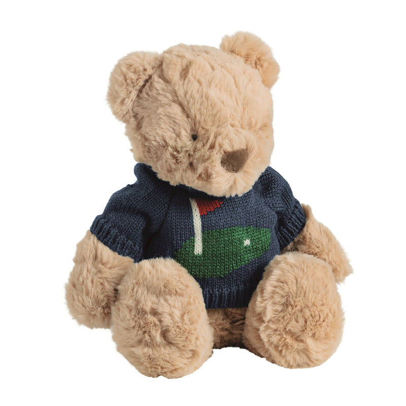 Teddy bear wearing a blue sweater with a logo on a white background