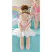 Toy ballerina doll with a rainbow and another doll in the background