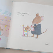 Illustrated book page with a mouse holding a baby mouse, on a plain background.