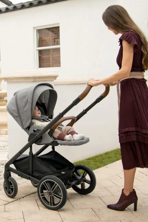 mom pusinh baby in a Nuna stroller