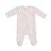 A soft oatmilk-colored velour footie with a diagonal zipper and built-in feet.