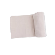Folded beige fabric on a white background
