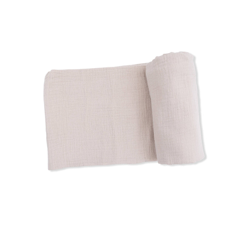 Folded beige fabric on a white background