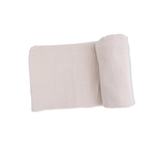 Folded beige fabric on a white background